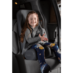 A girl enjoying sitting in the comfortable booster car seat.